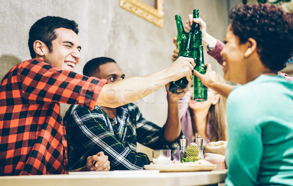 Happy friends toasting bio organic beer in bar pub restaurant -  Stock photo © DisobeyArt