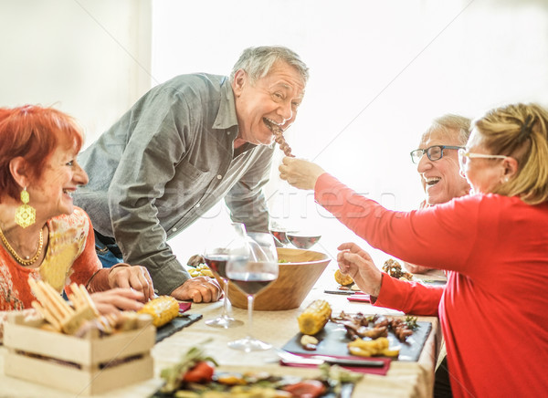 Happy senior friends having barbecue lunch at home - Old people  Stock photo © DisobeyArt