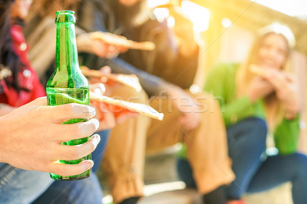 Group of happy friends toasting beer and eating pizza take away  Stock photo © DisobeyArt