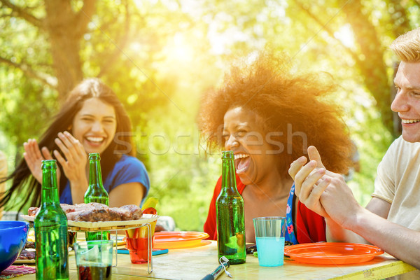 Stock photo: Happy friends having barbecue meal outdoor with back sun light -