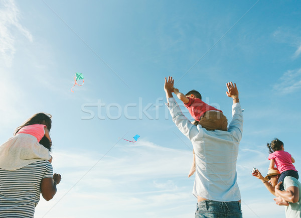 Families with children flying with kites on the beach at sunset  Stock photo © DisobeyArt