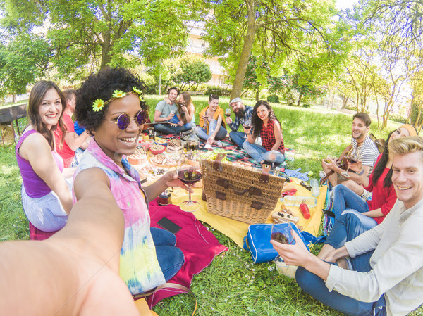 Happy afro woman taking selfie at picnic outdoor with her friend Stock photo © DisobeyArt