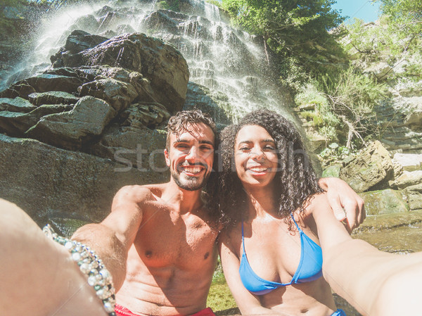 Happy couple taking selfie portrait with smartphone camera under Stock photo © DisobeyArt