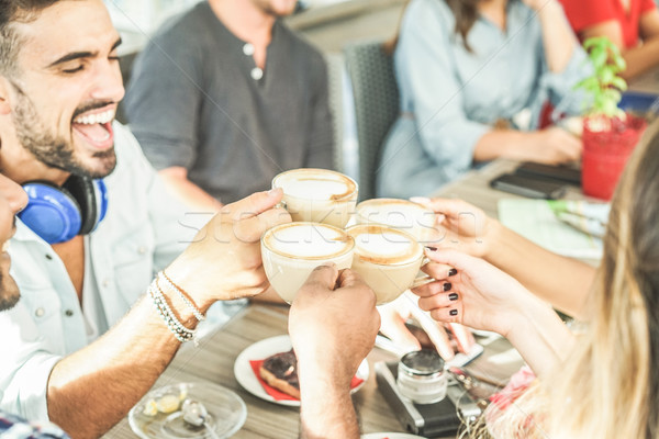 Stock photo: Happy friends toasting cappuccino at bar cafe - Young trendy peo