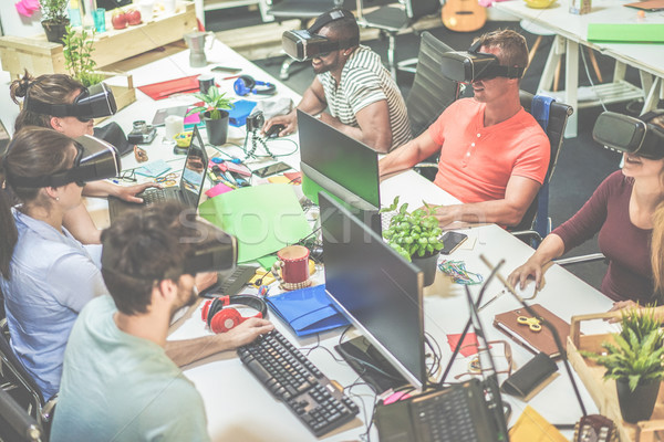 Young teamwork using virtual reality glasses in creative office  Stock photo © DisobeyArt