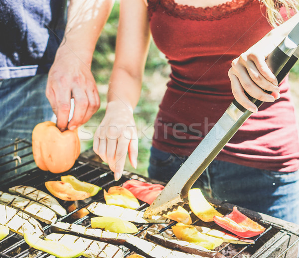 Young woman cooking vegetables at barbecue dinner outdoor - Coup Stock photo © DisobeyArt