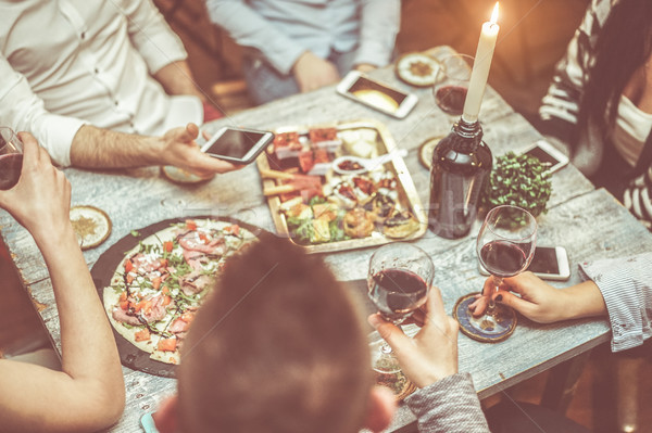 Group of friends toasting red wine in italian winery bar - Young Stock photo © DisobeyArt