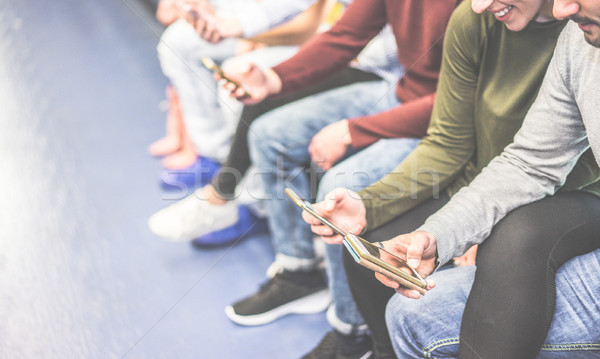 Stock photo: Group of friends using mobile phones in metro subway - Concept o