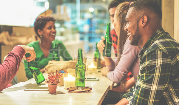 Happy multi ethnic friends toasting bio organic beer in bar pub  Stock photo © DisobeyArt