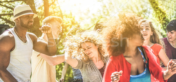 Happy diverse culture friends dancing into the wood party on sum Stock photo © DisobeyArt