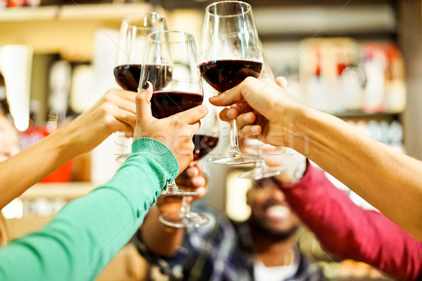 Group of students cheering with red wine at aperitif dinner bar  Stock photo © DisobeyArt
