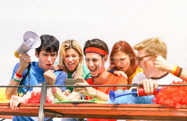 Young supporters from different countries watching sport on mobi Stock photo © DisobeyArt