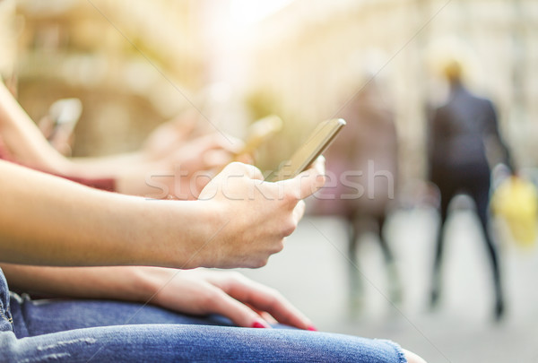 Stock photo: Group of friends watching mobile phones in city - Young people a