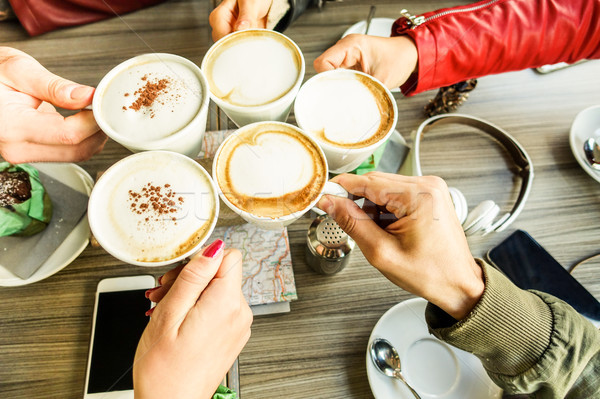 Friends group toasting cappuccino and milk with cocoa - Close up Stock photo © DisobeyArt