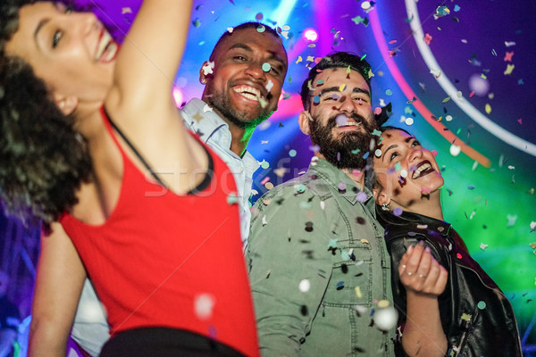 Happy friends having fun in night club dance floor with canon ba Stock photo © DisobeyArt