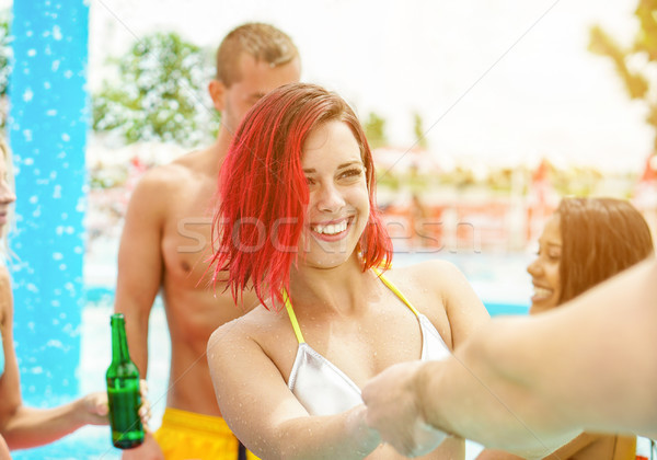 Happy friends having party in aqua park swimming pool toasting b Stock photo © DisobeyArt