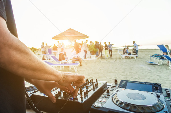Dj mixing at sunset beach party in summer vacation - Disc jockey Stock photo © DisobeyArt