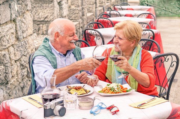 Senior couple drinking and eating in bar outdoor - Man having fu Stock photo © DisobeyArt