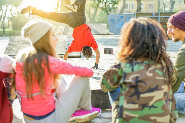 Stock photo: Happy friends listening music in skateboard city park with man b