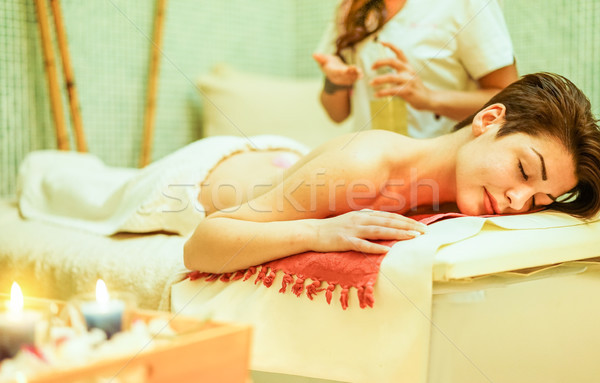 Young woman having back oil therapy massage in spa resort hotel  Stock photo © DisobeyArt