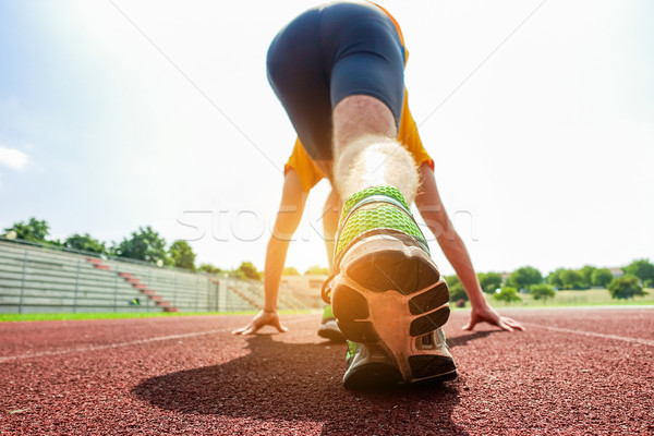 Runners feet in a athletic running track - Young man athlete tra Stock photo © DisobeyArt