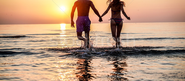 Couple of lovers running on the beach in tropical place for summ Stock photo © DisobeyArt