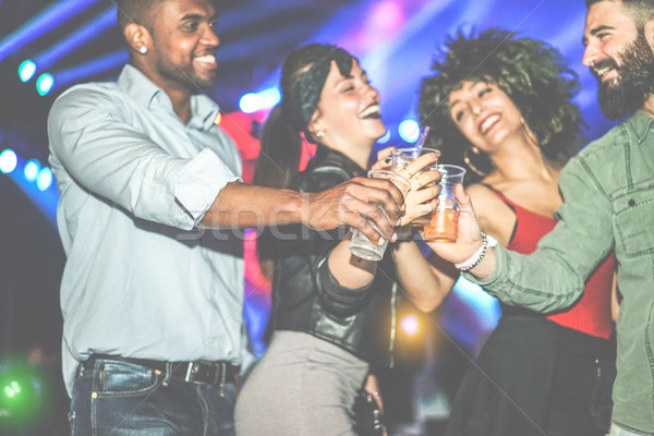 Happy diverse culture friends having party in club at night - Yo Stock photo © DisobeyArt
