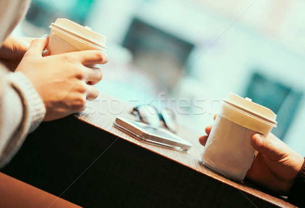 Two friends drinking coffee in paper take away cup - People havi Stock photo © DisobeyArt