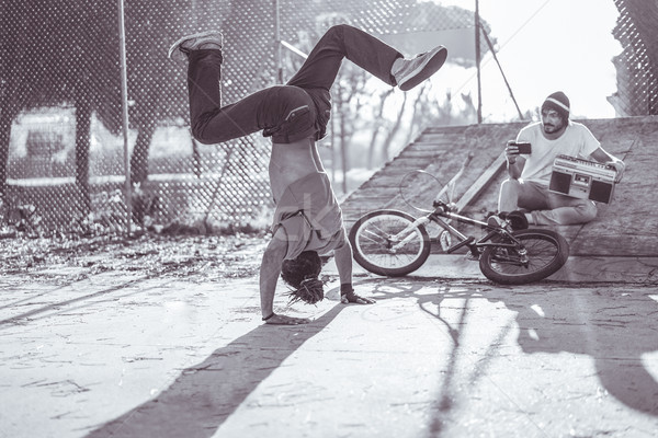 Young man making video of rasta breakdancing perfoming in city p Stock photo © DisobeyArt