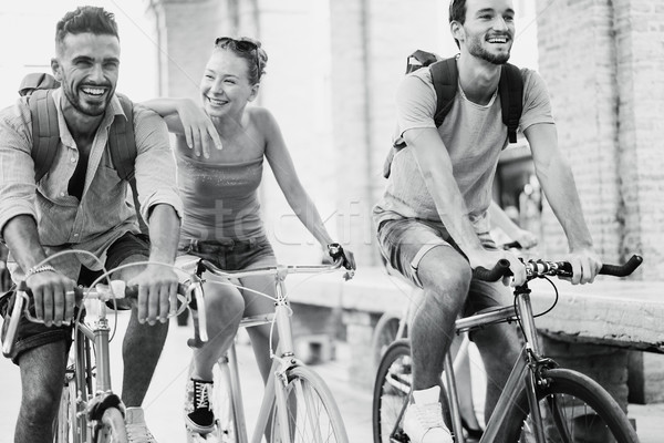 Happy friends riding old style bicycles - Young people having fu Stock photo © DisobeyArt