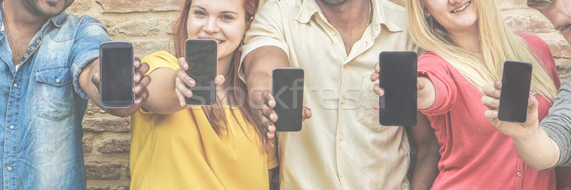 Diverse culture friends with smartphone outdoors - Young multi e Stock photo © DisobeyArt