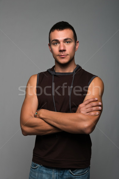 Knap jonge man mouwloos jeans jongen shirt Stockfoto © disorderly