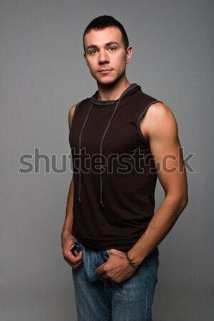 Knap jonge man mouwloos jeans jongen shirt Stockfoto © disorderly