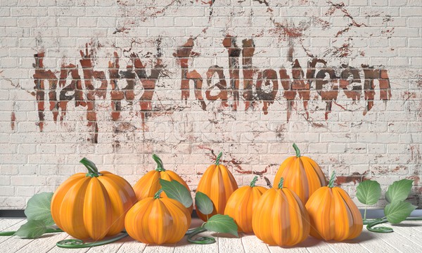 Happy Halloween greeting with pumpkins and green leafs on wooden Stock photo © djmilic