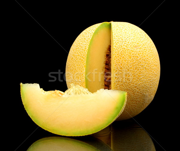 Melon galia notched with slice isolated black in studio Stock photo © dla4