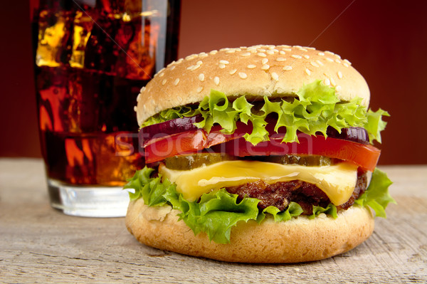Cropped photo of cheeseburger,glass of cola on wooden table Stock photo © dla4