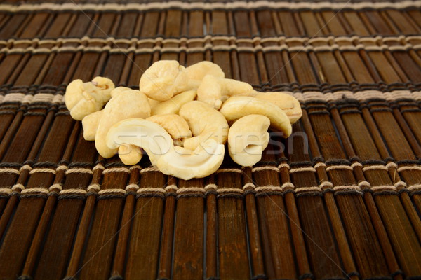 Studio shot of cashew nuts on brown mat Stock photo © dla4