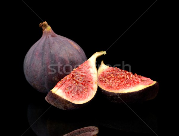 Quarters of figs isolated on black background  Stock photo © dla4