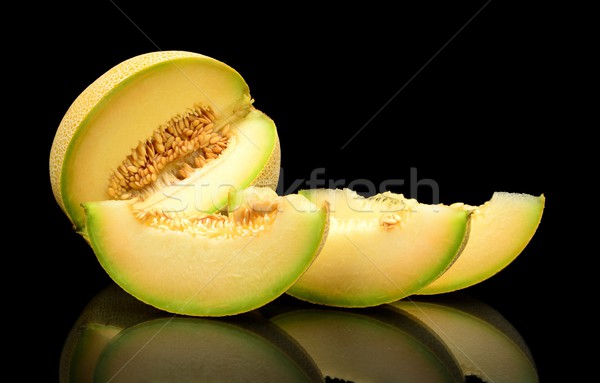 Melon galia notched with slices isolated black in studio Stock photo © dla4
