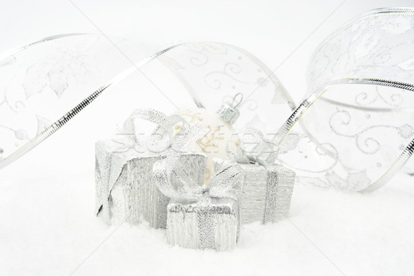 Silver christmas gifts with silver ribbon on snow Stock photo © dla4