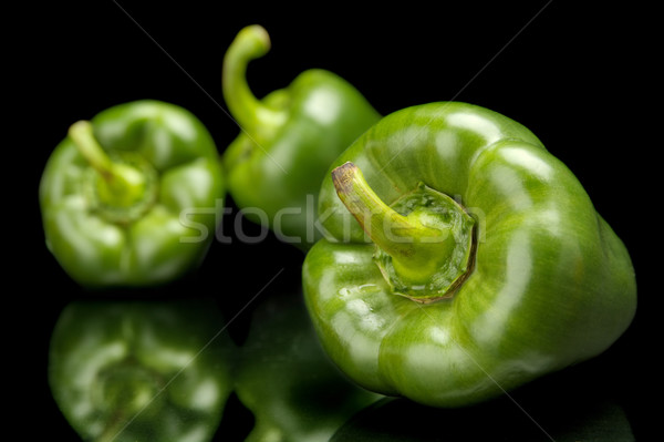Group of green bell peppers in the corner isolated on black Stock photo © dla4