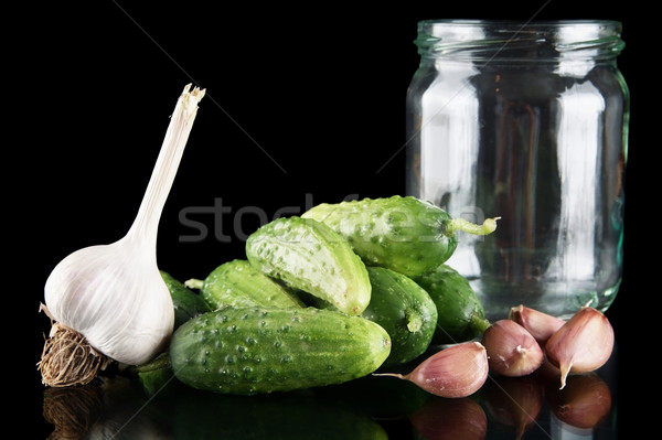 Gherkins in jar preparate for pickling on black Stock photo © dla4