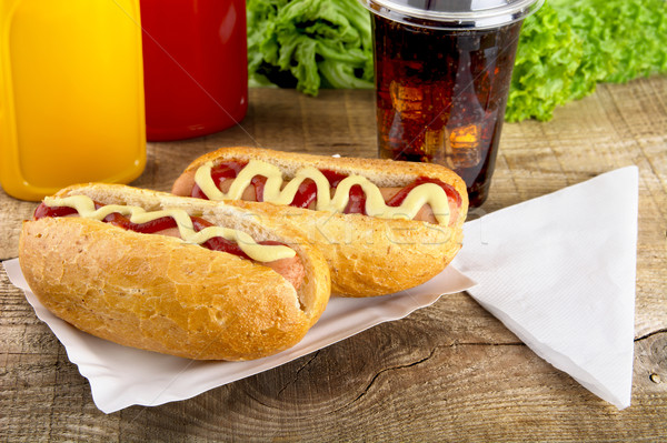 Hotdogs in the tray with ketchup with cola,lettuce on the wooden Stock photo © dla4