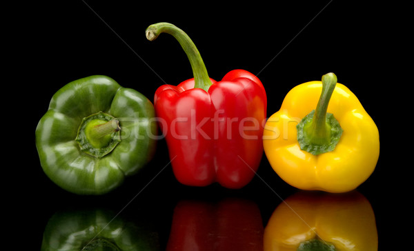 Red,green,yellow bell peppers isolated on black Stock photo © dla4