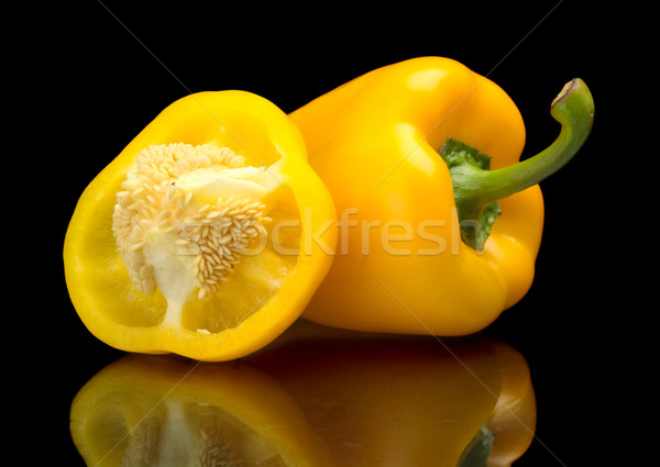 Closeup halved yellow bell peppers isolated on black Stock photo © dla4