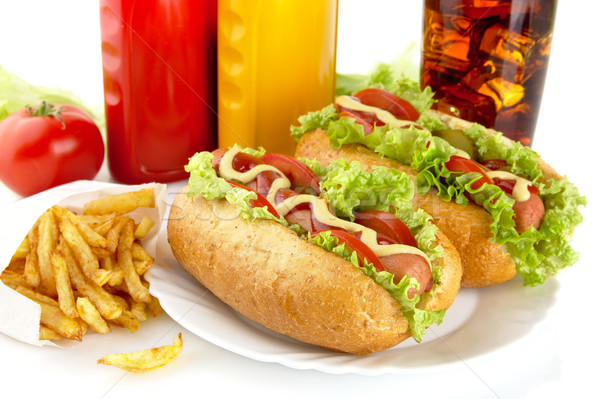 Hotdogs on plate with cola and french fries on white Stock photo © dla4