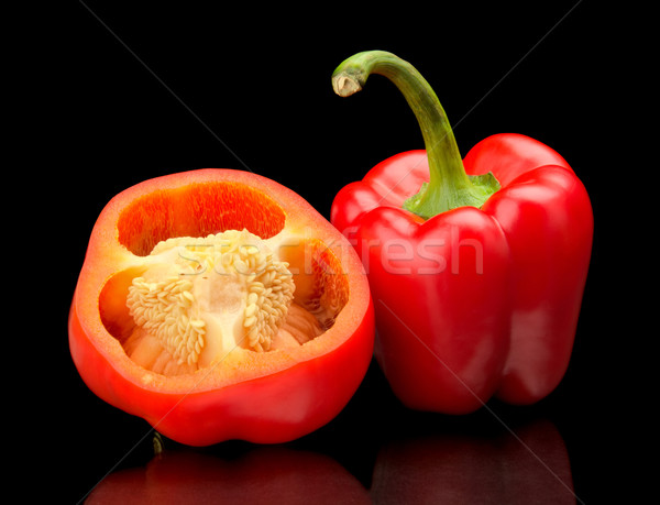 Closeup halved red bell peppers isolated on black Stock photo © dla4