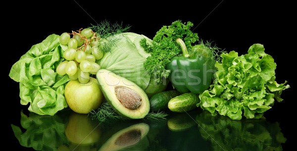 Collection of green vegetables and fruits on black Stock photo © dla4