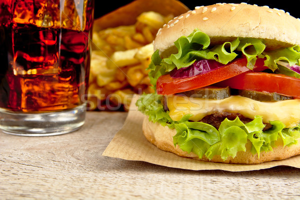 Cheeseburger,glass of cola and french fries on wooden Stock photo © dla4