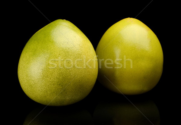 Two pomelos chinese grapefruits isolated on black Stock photo © dla4